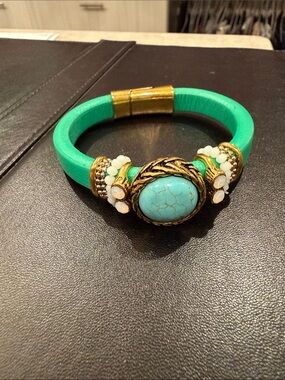 Turquoise leather bracelet with beadwork and gold colored accents